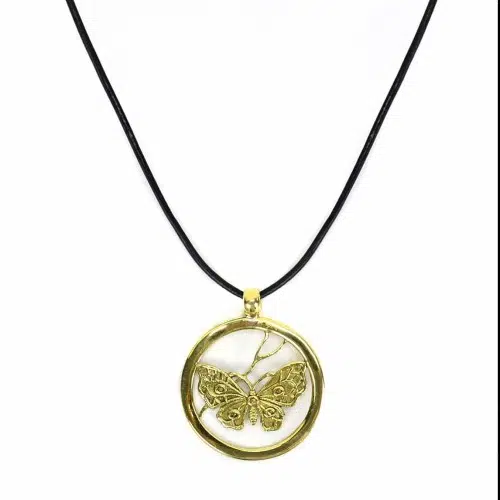 A picture of the mariposa necklace, made from alpaca silver with a butterfly in the middle of the circle.