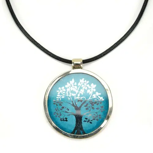 A picture of a silver necklace with a white tree in the middle.