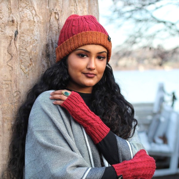 A young women wearing the red and orange knit hat