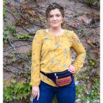 Girl wearing navy blue flat suede fanny pack