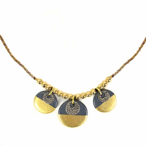 A picture of the gilded charm necklace, has three clay disk, that has been painted over.