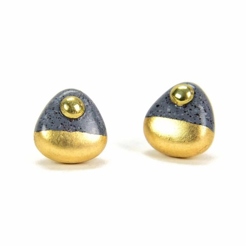 A picture of some stud earrings, that have been made from clay beads, and then painted with gold and silver.