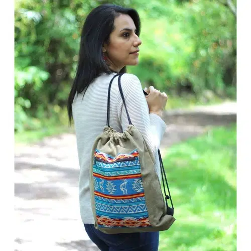 Girl carrying tan canvas tribal drawstring bag
