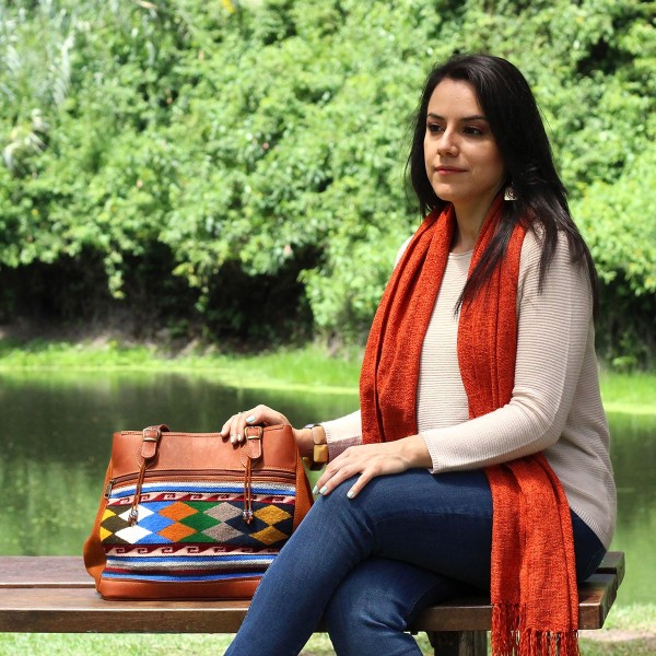 Girl sitting on a bench next to Vitoria bag with checkered pattern