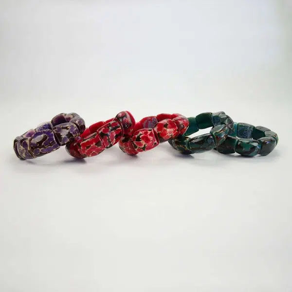 A bracelet made from chunky square and comes in a bundle of 5, the colors include are, purple, red, red, teal, and teal.