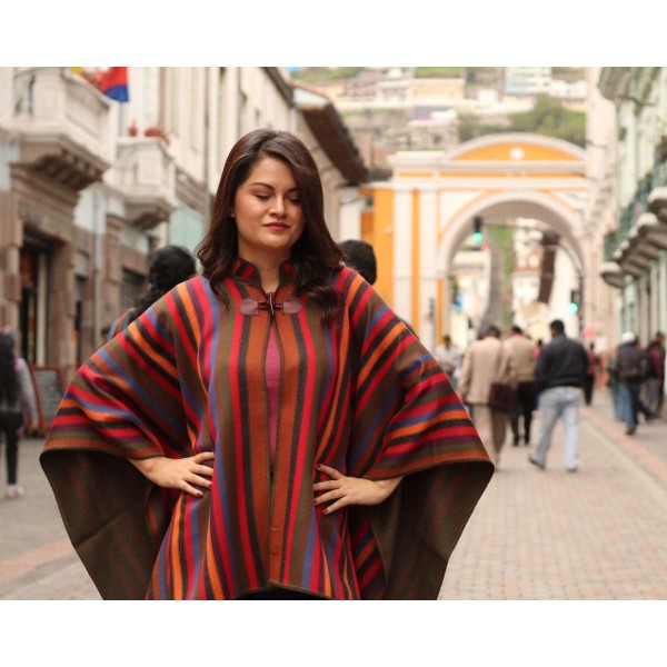A young women wearing the rainbow alpaca cape, this brightly colored cape is made to fit everyone