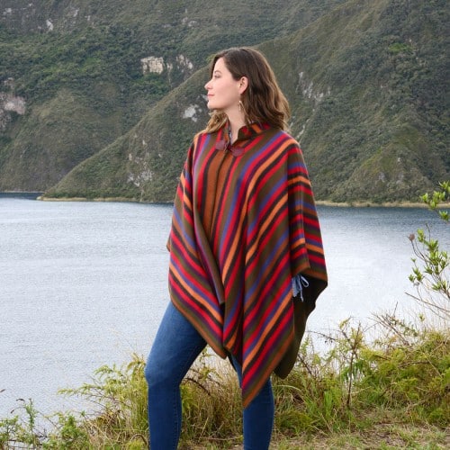 A young women wearing the rainbow alpaca cape, this brightly colored cape is made to fit everyone