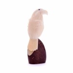 A hand carved eagle sitting on a tagua seed, this eagle was also made out of a tagua seed.