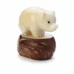 A pig standing on a platform, hand carved from tagua nuts.