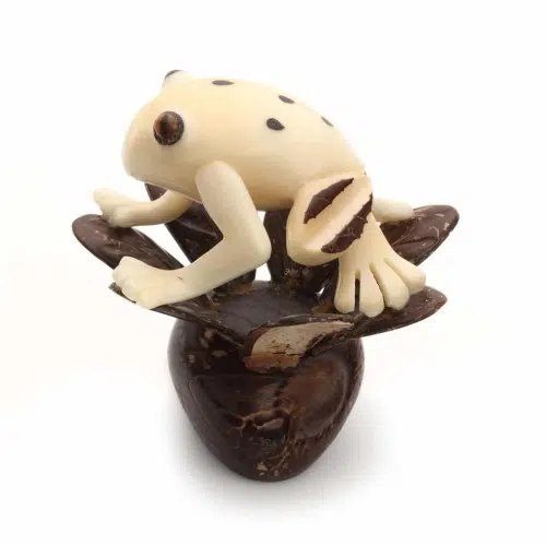 A frog sitting in a tree, made from a tagua seed, and hand carved.