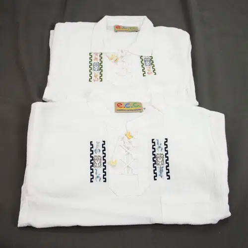 A bundle of four long sleeve shirts that have a design on the side of them