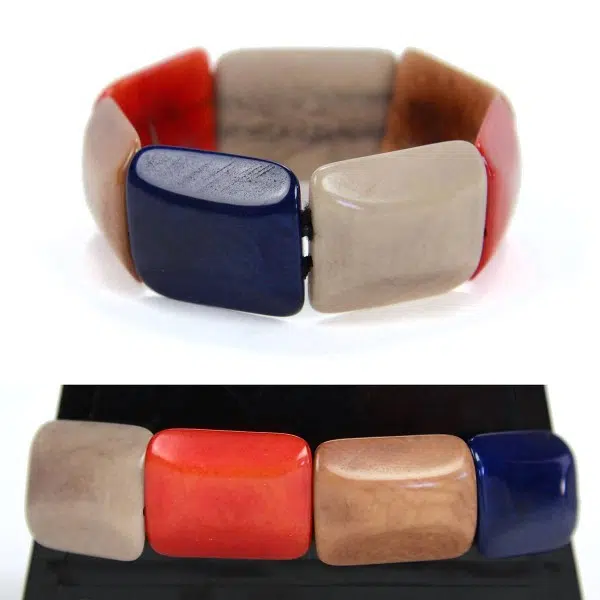 Square tagua pieces put together to create a bracelet, coming in a verity of colors, this color is blue, red, and grey.
