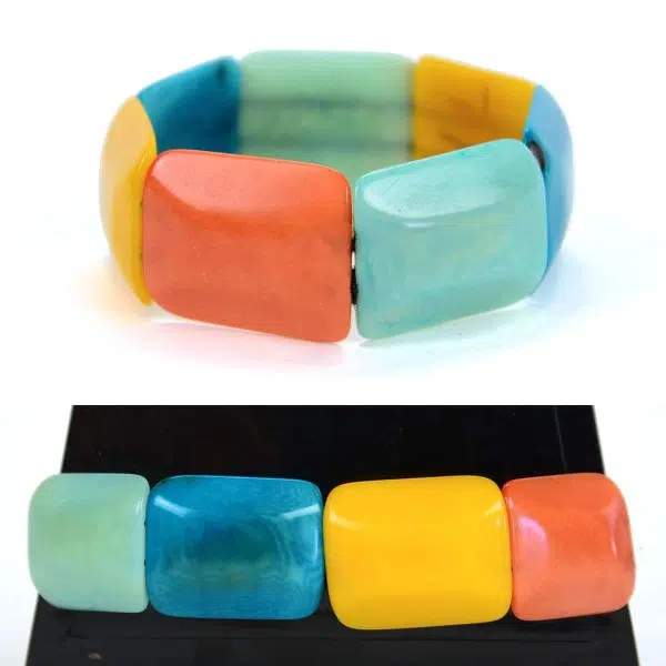 Square tagua pieces put together to create a bracelet, coming in a verity of colors, this color is green, turquoise, blue, yellow, and pink.
