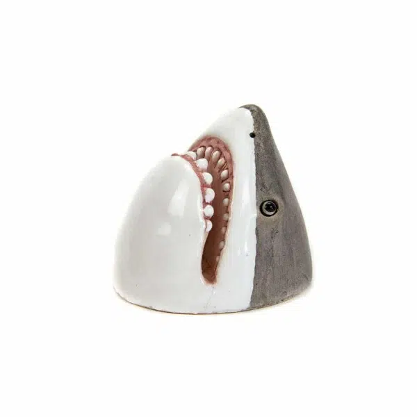 A ceramic card holder that looks like a shark.