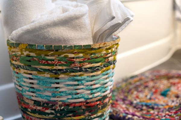A close up of the sari waste basket holding towels
