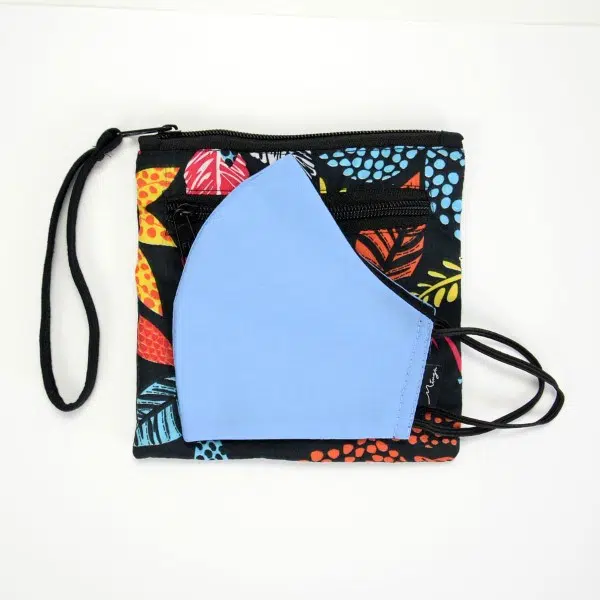 black square pouch with colorful leafs pattern and light blue face mask