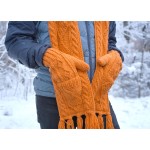 Someone wearing the bright orange hand knit wool hat, showing the two pockets built into the scarf