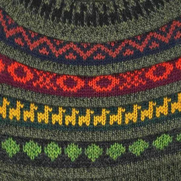 Close up of the dark green hat, showing the lightly colored designs