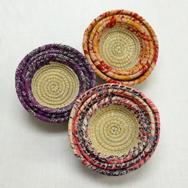A top down picture of three colors that the sari palm leafs come in, those colors are, purple and white, red and orange, and pink white