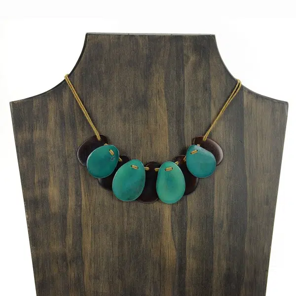A picture with nine slices of tagua arranged on the necklace, comes in a verity of colors the color in this picture is brown and turquoise.