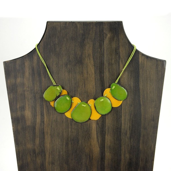 A picture with nine slices of tagua arranged on the necklace, comes in a verity of colors the color in this picture is green, and yellow.