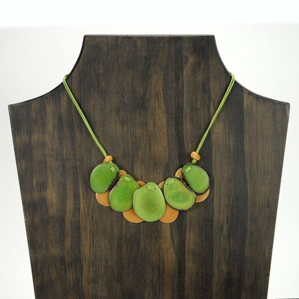 A picture with nine slices of tagua arranged on the necklace, comes in a verity of colors the color in this picture is yellow, and green.