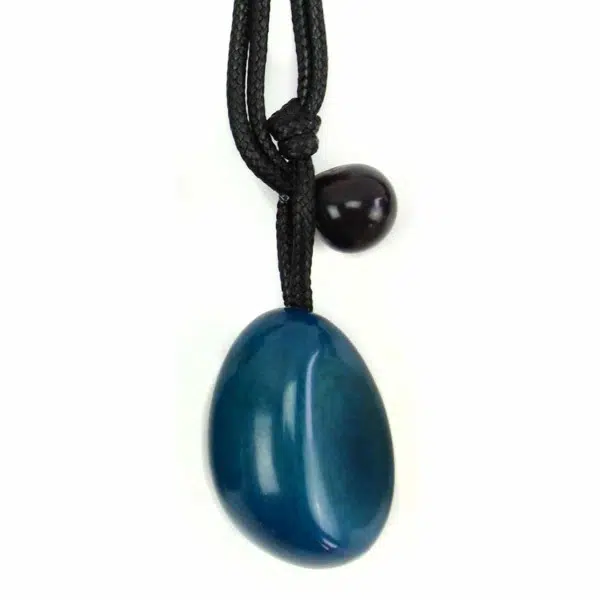 A close up picture of a blue tagua seed necklace.