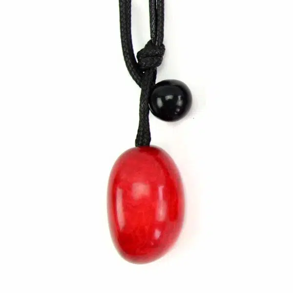 A close up picture of a red tagua seed necklace.