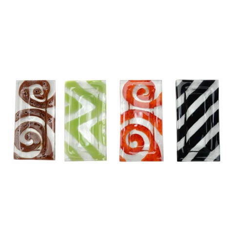 four different dishes that have designs on them all in different colors.