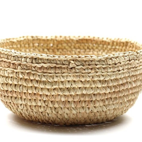 A hand braided basket, this basket is made out of straw