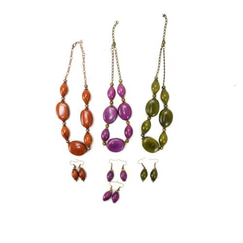 A picture of three necklaces and earrings, they come in three colors, orange, purple, and green.